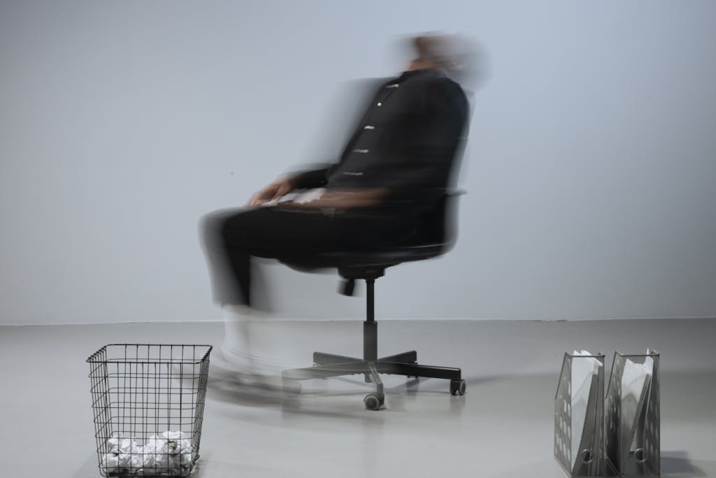 Dynamic blurred image depicting stress in a modern office setting.